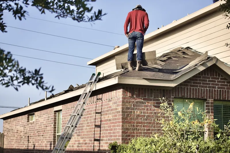 Professional roofer working on a residential roof in Moapa Valley